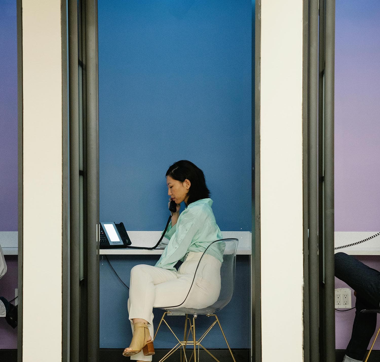 Person sitting alone in a confined space, representing isolation in remote communication